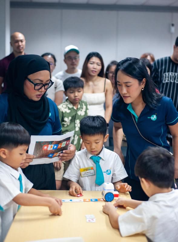 ChildFirst educators guiding children through the Coding with Photon station